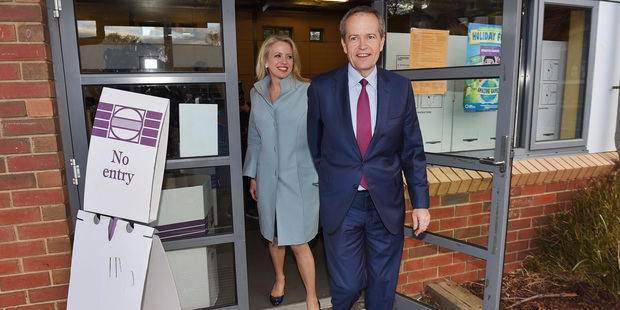 Australia's opposition leader Bill Shorten and his wife, Chloe, leave the polling place after casting their votes. Photo / AP