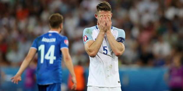 England's Gary Cahill covers his face during the Euro 2016 round of 16 soccer match between England and Iceland. Photo / AP.
