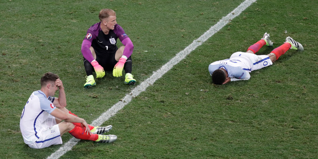 England players Gary Cahill, Joe Hart and Dele Alli react after losing to Iceland. Photo / AP