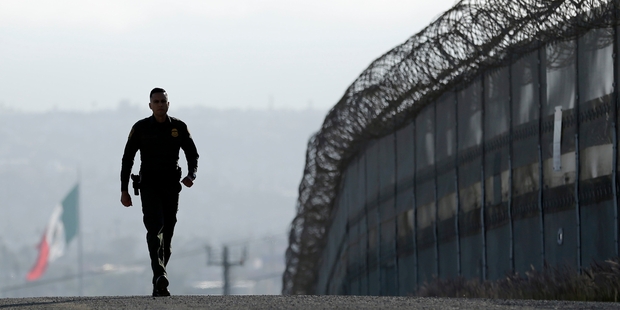 It's crazy to imagine building a wall, like the one pictured between Tijuana and San Diego, will solve the issues raised by immigration. Photo / AP