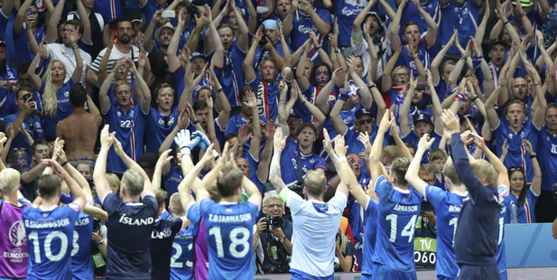 Iceland players celebrate with their supporters at the end of the Euro 2016 round of 16 match between England and Iceland. Photo / AP