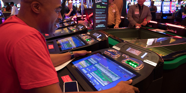 Terry Redd places his bet in a computer-assisted craps game at Maryland Live Casino in Hanover, United States. Photo / The Washington Post