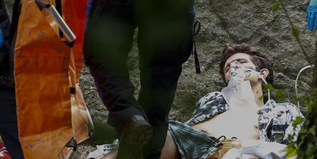 A critically injured man lies on the ground as he receives assistance after explosion was detonated on central park in New York. Photo / AFP