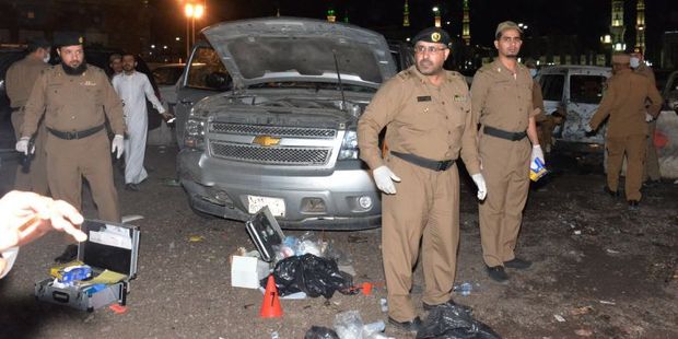 Saudi security personnel gather at the site of the suicide attack near the security headquarters of the Prophet's Mosque in Medina City. Photo / AFP