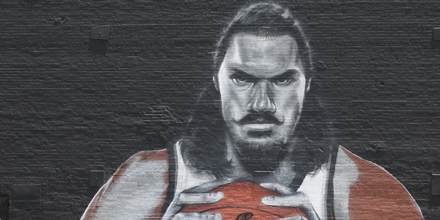 Two men take a selfie in front of a mural of NBA Oklahoma City Thunder center Steven Adams. Photo / AP