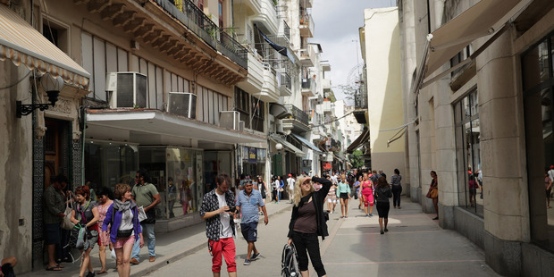 Tourists walk the narrow streets of the shopping district in the historic Habana Vieja, old Havana, Cuba. Photo / Chip Somodevilla
