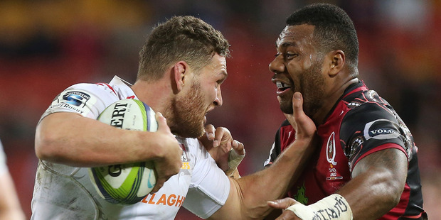 Tawera Kerr-Barlow plants a fend on Samu Kerevi of the Reds. Photo / Getty