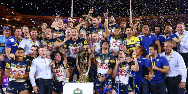 The Cowboys celebrate on the podium with the premiership trophy after winning the 2015 NRL Grand Final. Photo / Getty Images.