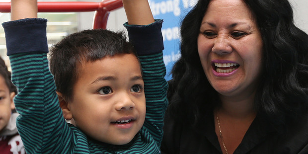 Paula Poihipi from Jumping Beans helps Blake Aukuso. Jumping Beans chiefs say kids' eating and activity habits form early. Photo / Doug Sherring