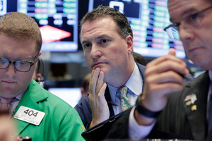 Trader Jonathan Corpina, centre, works on the floor of the New York Stock Exchange. Photo / AP