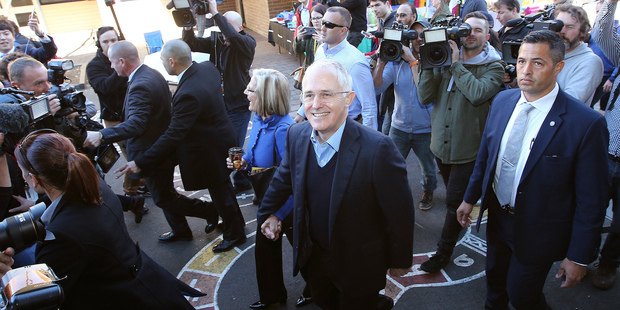 Australian Prime Minister Malcolm Turnbull, center, leaves his polling station after he cast his votes in the federal election at the Double Bay public school in Sydney. Photo / AP