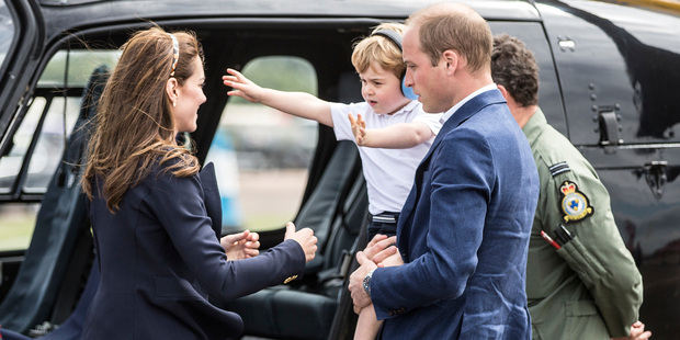 Prince George, his mother Kate and father William check out a Squirrel helicopter. Photo / AP