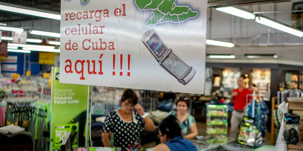 Customers buy state-of-the-art phones for family and friends in Hialeah, Florida. Photo / Angel Valentin