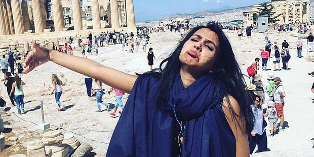 In most photos she also had an arm outspread as if hugging her absent husband. Photo / Facebook, Outside Girl