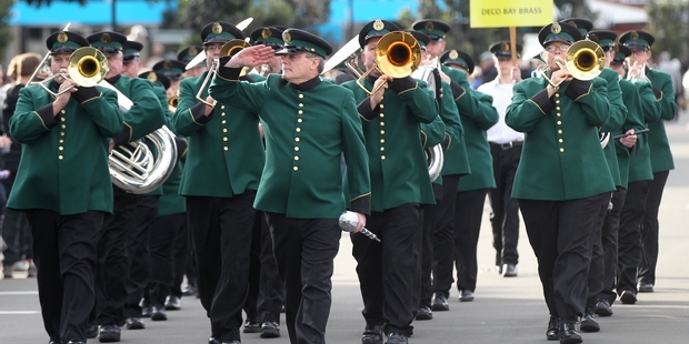 IN STEP: Deco Bay Brass, taking part in the 2016 Deco Bay Festival of Brass, march down Hastings St, Napier, yesterday. PHOTO/DUNCAN BROWN