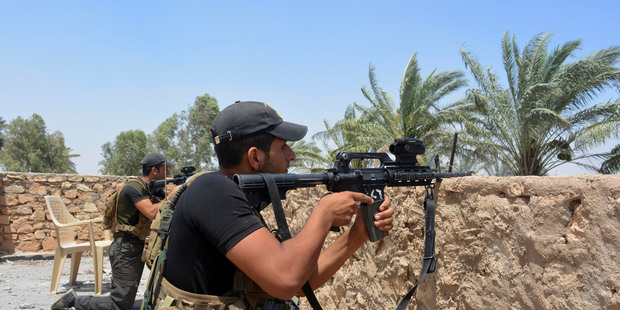Iraqi soldiers scan the area during a military operation to regain control of villages north of Ramadi. Iraq is planning to launch an operation to regain Mosul from Isis. Photo / AP