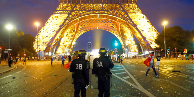 Riot police near the Eiffel Tower in Paris last weekend. Photo / AP