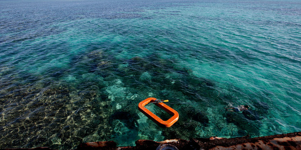 A Philippine Marine swims in the waters of Second Thomas Shoal in the South China Sea. Photo / AP