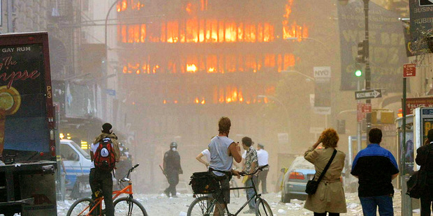 People walk in the street in the area where the World Trade Center buildings collapsed September 11, 2001. Photo / Getty