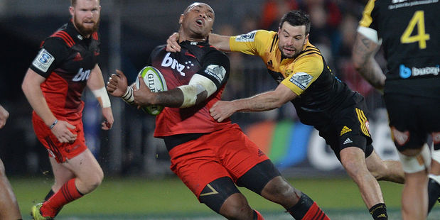 Nemani Nadolo of the Crusaders is tackled by James Marshall of the Hurricanes. Photo / Getty