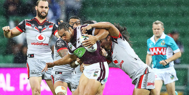 Martin Taupau of the Sea Eagles is tackled by the Warriors defence. Photo / Getty