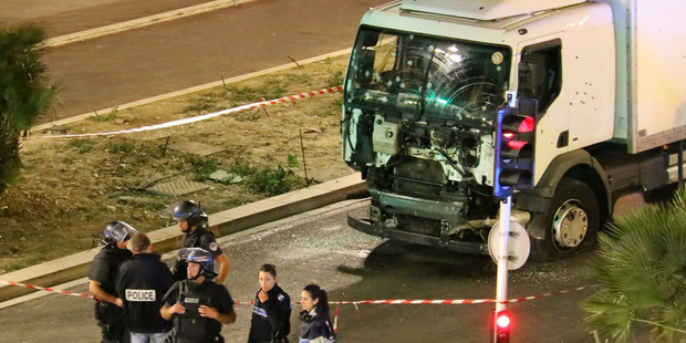 Police investigate the scene after a truck plowed through Bastille Day revellers. Photo / AP
