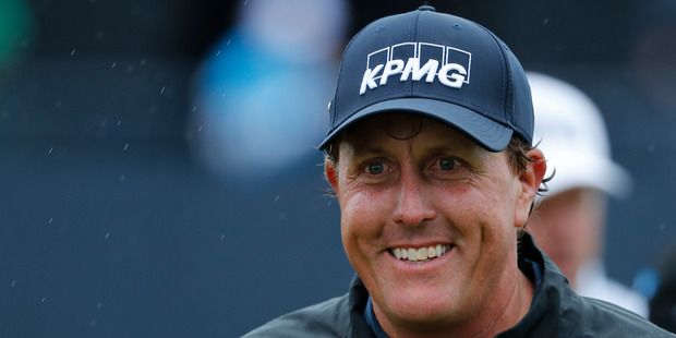 Phil Mickelson of the United States smiles as he walks off the 18th green after completing his second round of the British Open Golf Championships. Photo / AP