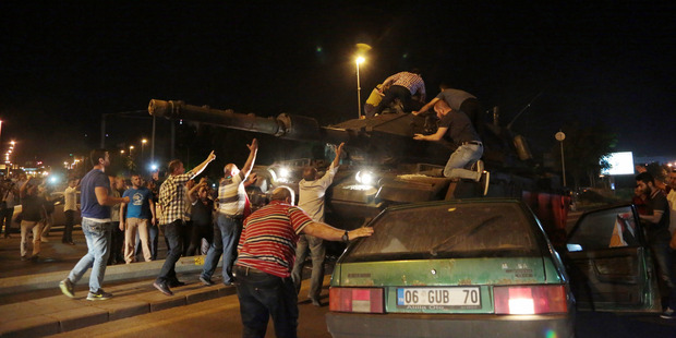 Tanks move into position as Turkish people attempt to stop them, in Ankara, Turkey. Photo / AP