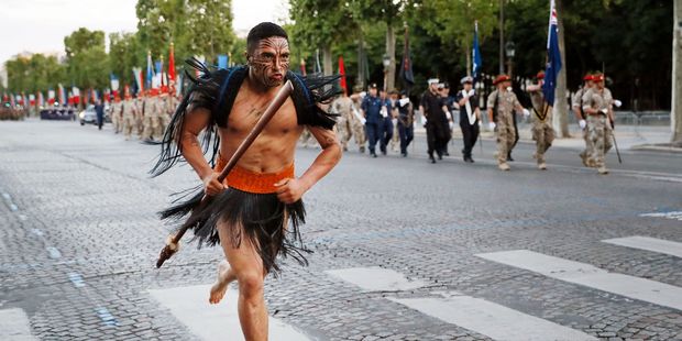 A Maori soldier runs as New Zealand's soldiers march down the Champs Elysees in Paris during a rehearsal of the annual Bastille Day military parade. Photo / Thomas Samson/AFP/Getty Images