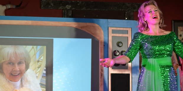 Ali Harper performs in front of a large television prop showing a photo of Doris Day herself at her 92nd birthday celebrations. Photo / Rebecca Patterson
