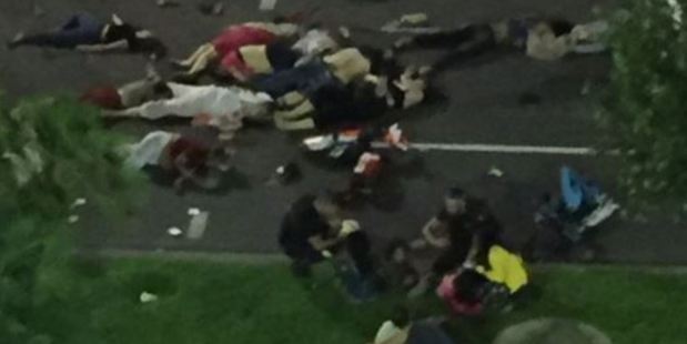 Emergency workers treat patients lying in the road. Photo / Twitter