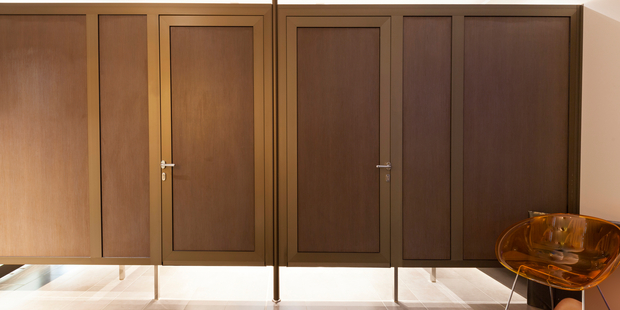A woman saw someone taking photos or filming with an iPhone over the top of a changing room wall. Photo / iStock