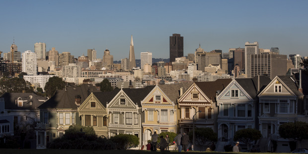 The downtown skyline stands past Victorian homes in San Francisco, United States. Photo / Bloomberg