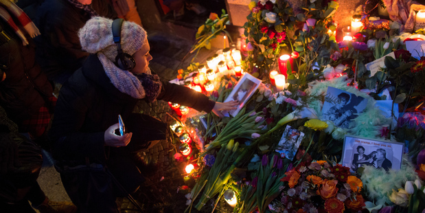 Flowers, candles and photographs are placed in front of the apartment building where David Bowie once lived in Berlin, Germany. AP photo / Kay Nietfeld