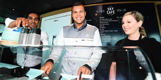 Jo-Wilfried Tsonga mixes his own icecream while David Ferrer signs a jeraboam of champagne. Inset, bottom: Wayne Howett.