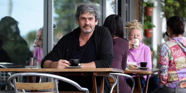 Herald on Sunday columnist Paul Little ponders a move to The Hokianga while drinking coffee in the urban environment of West Lynn Auckland. Photo / Doug Sherring