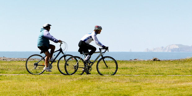 Cyclists take advantage of the warm weather to cruise the Rotary Pathway along Awatoto.