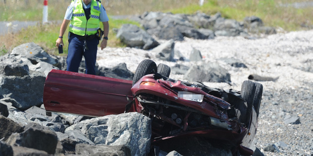 Emergency services are at Awarua Bay after a car has crashed off the road onto rocks, on the Firth of Thames. Photo / SNPA / Ross Setford