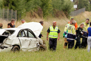 Police and emergency services at the scene of a crash where a car roled on the Expressway near Hastings. Photo / Warren Buckland