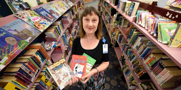 POPULAR: Team leader for children and teenage services Michelle Anderson with the city's most popular library books.PHOTO/GEORGE NOVAK
