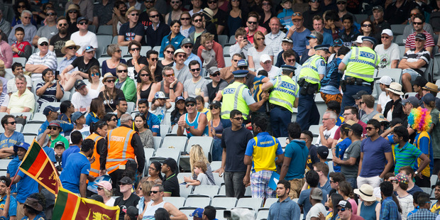 Police escort some Sri Lankan fans from the East Stand at Eden Park. Photo / Jason Oxenham