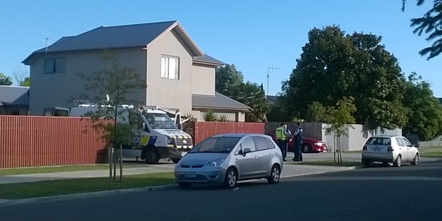 Police said they were working to try and get a man down from a roof. Photo / Duncan Brown