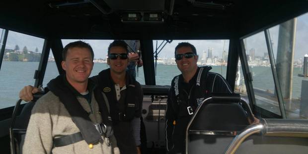 Michael Jenkins and two members of the Coastguard make their way to the mainland after Jenkins was picked up. Photo/Supplied