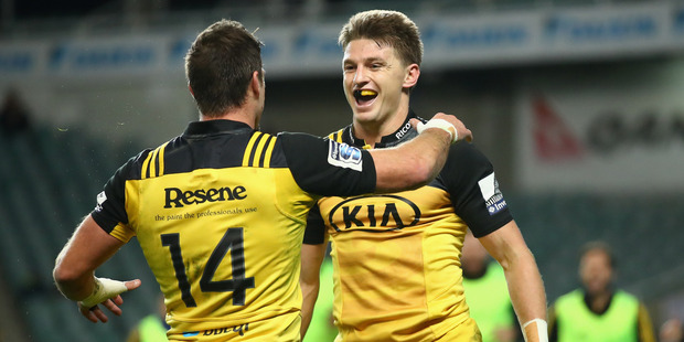Beauden Barrett of the Hurricanes celebrates scoring a try with team mate Cory Jane. Photo / Getty
