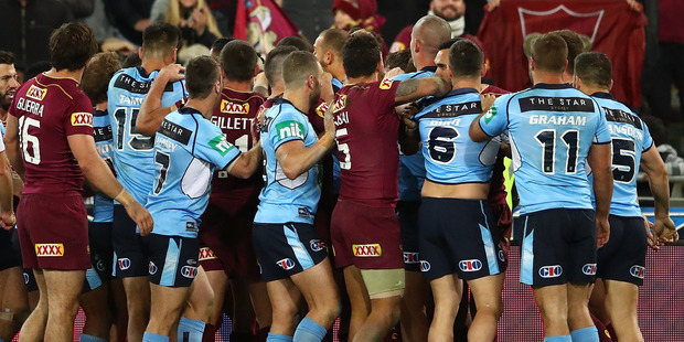Players from both the NSW Blues and Queensland Maroons wrestle during game three of State Of Origin. Photo / Getty