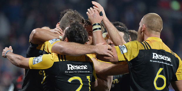 Callum Gibbins of the Hurricanes celebrates with team mates after scoring a try against the Crusaders. Photo / Getty