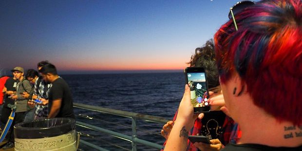 Pokemon Go players search for Pokemon at the Santa Monica Pier in Los Angeles. Photo / Getty Images