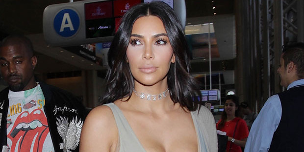 Kim Kardashian West enlisted the service of a "small police force" to surround her as she attended a Hamptons house party for a fashion label. Photo / Getty