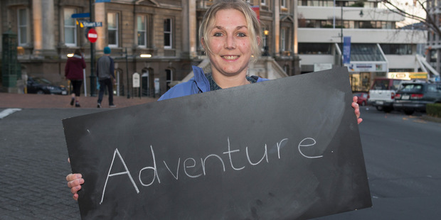 Sally Upsher, 33, of Mosgiel, in Dunedin with her chalkboard message on what it means to be a New Zealander. Photo / Mark Mitchell