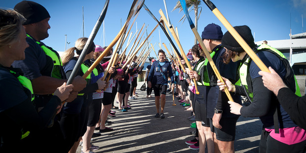 The police staff torch relay - Police officer Gaylene McFarlane takes the torch through a guard of honour after paddling across Pilot Bay in a waka. PHOTO/ANDREW WARNER